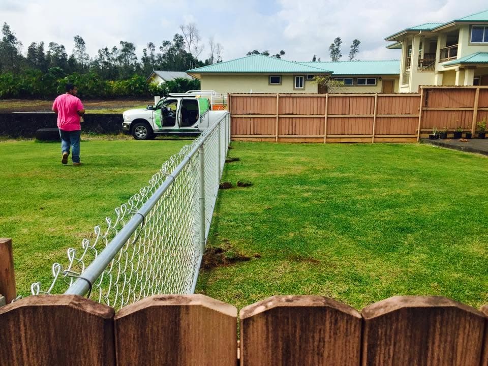 Wood and chain link fence installation crew on-site — On The Line Fencing project, Big Island, Hawaii