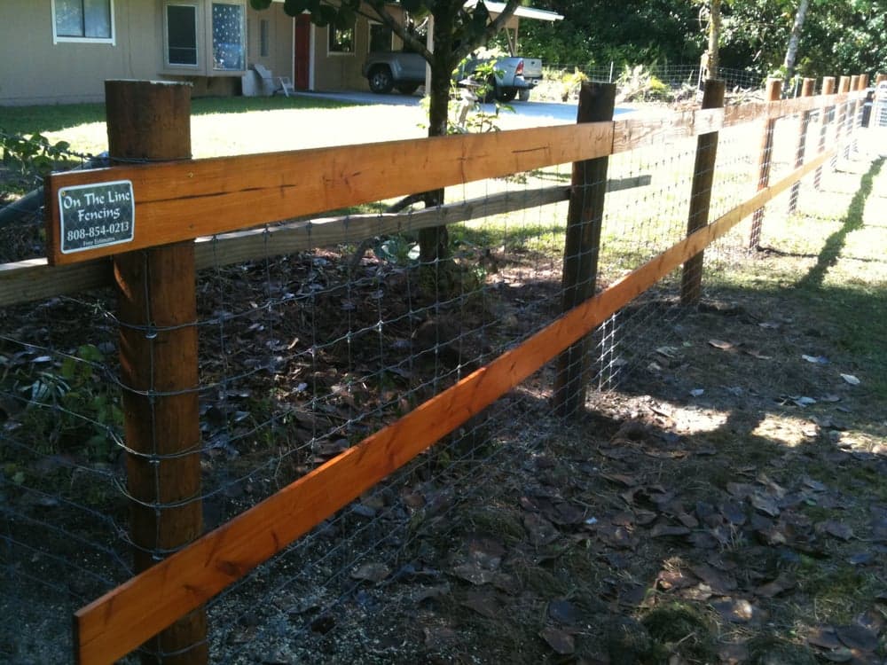 wood post stained with cetol and two rails with hog wire — On The Line Fencing project, Big Island, Hawaii